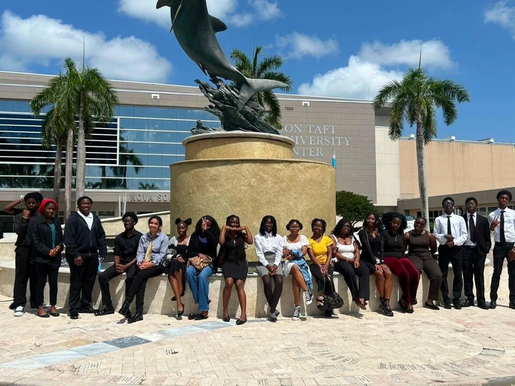 Students at Nova Southeastern University dolphin statue
