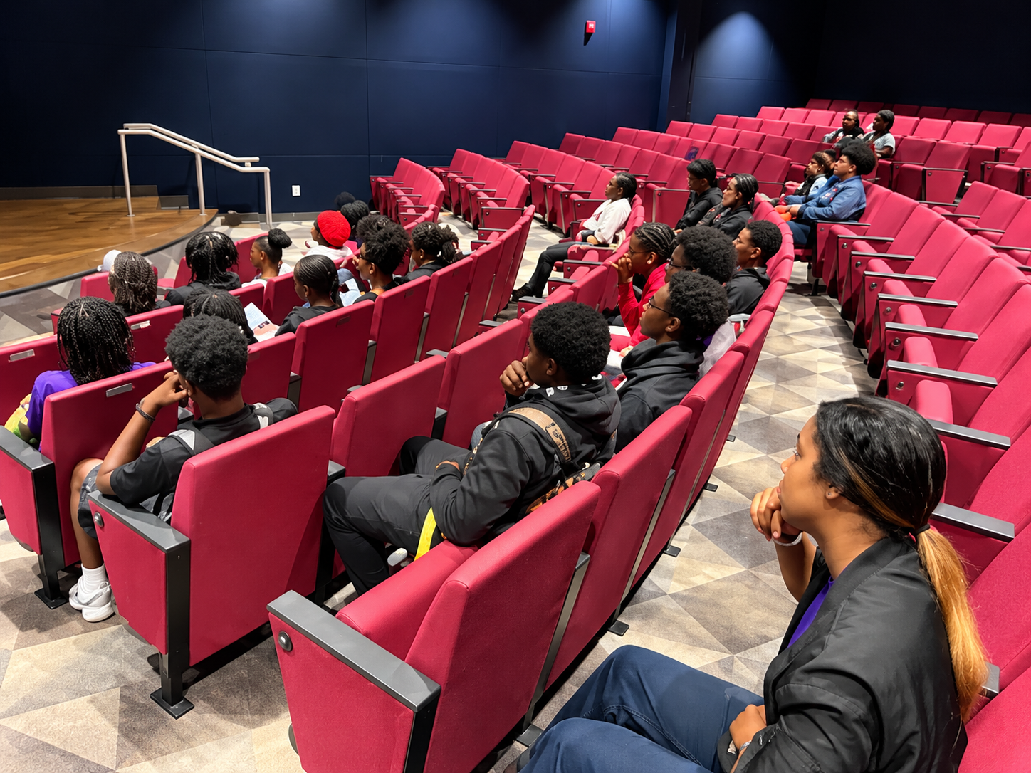 Students in theater auditorium during campus visit